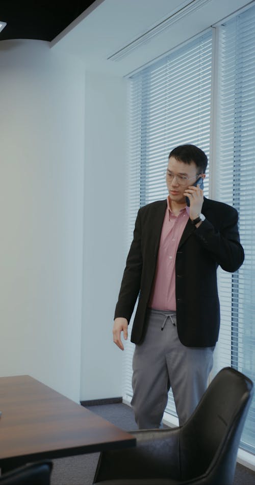 A Businessman Having a Phone Call in the Office