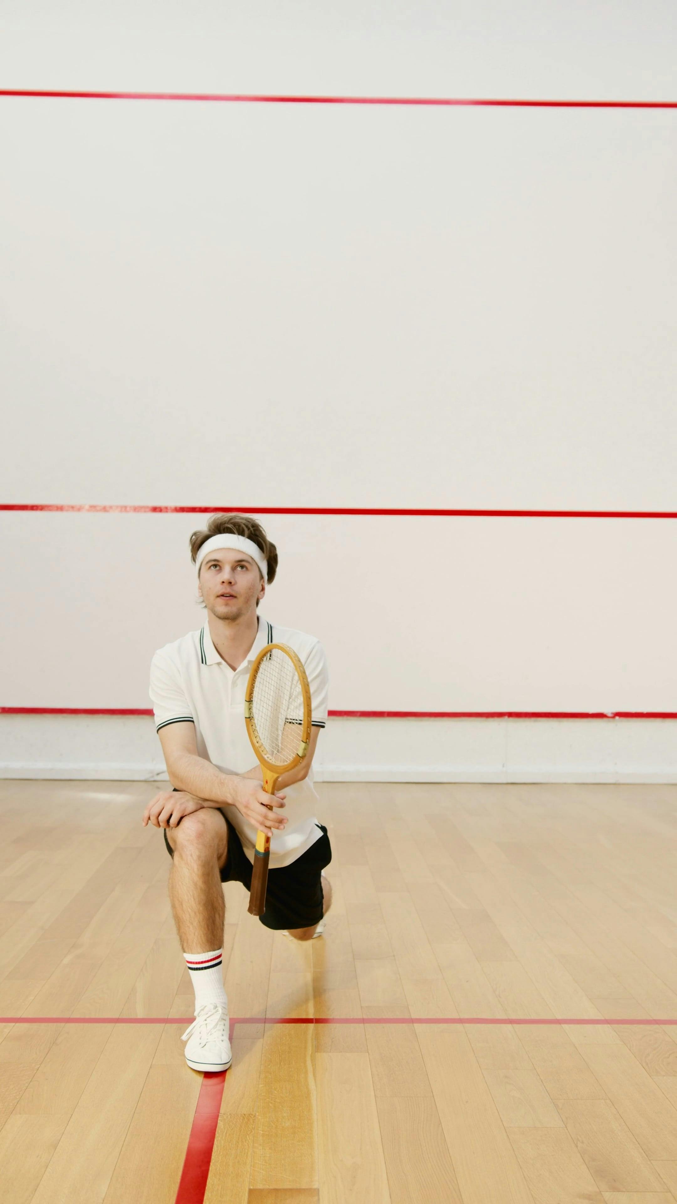 Sportsman Stretching his Legs while Holding a Squash Racket Free Stock  Video Footage, Royalty-Free 4K & HD Video Clip