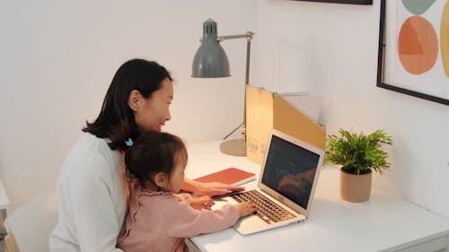Mother Using Laptop with Daughter