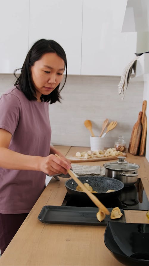 Woman Frying Dumplings