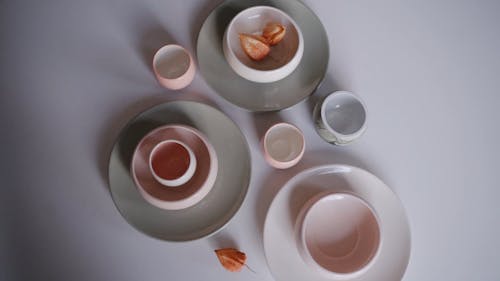 Ceramic Plates and Bowl on the White Table 