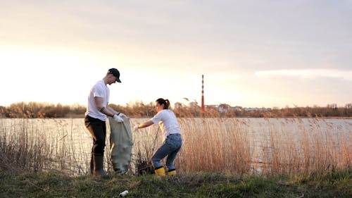 Man and Woman Collecting Trash