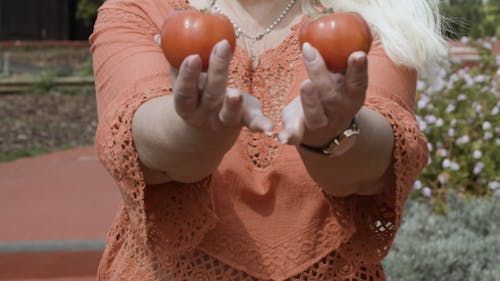 Woman Holding Tomatoes