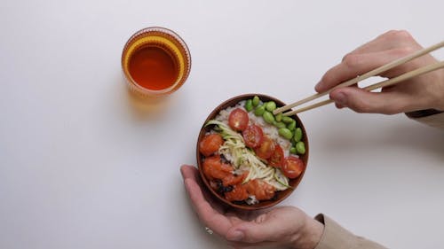 Person Eating Rice Bowl