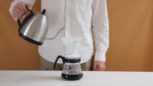 Man Pouring a Hot Water on the Coffee Filter