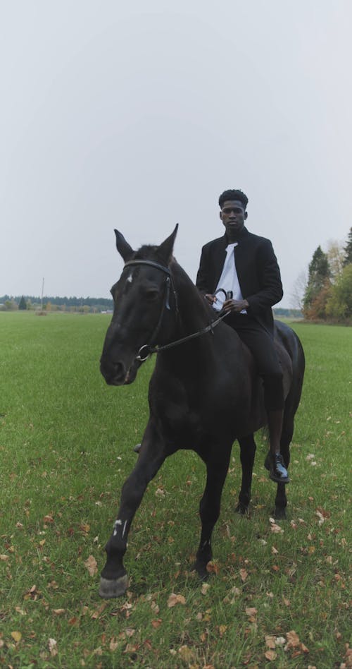 A Man Riding a Black Horse