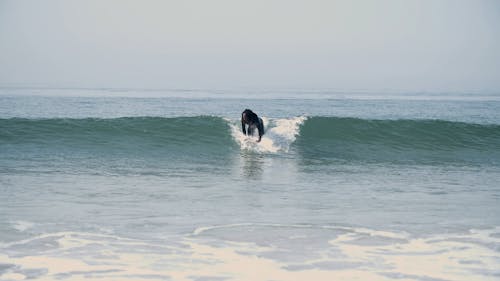 A Man Surfing at the Beach