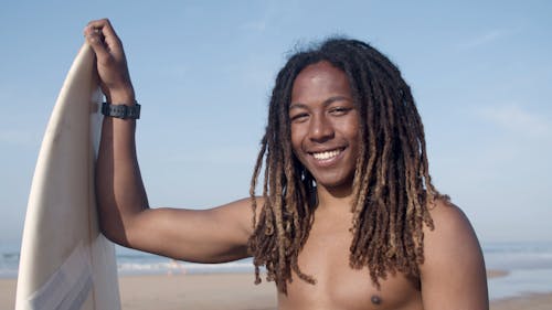 A Surfer Holding a Surfboard