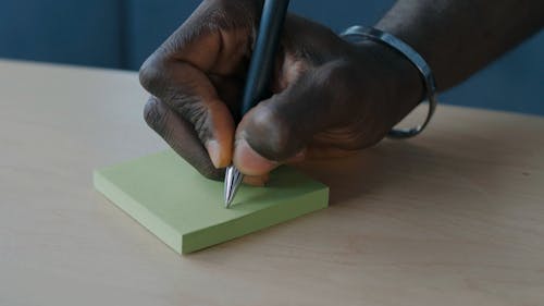 Man Writing on Sticky Notes