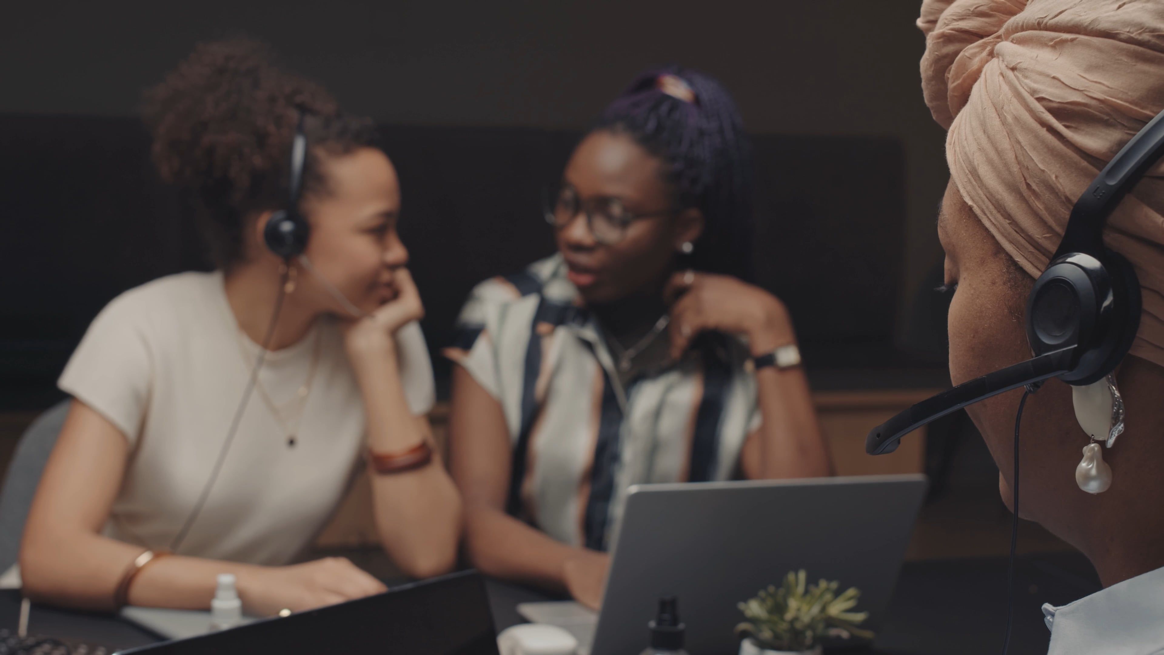 A Call Center Representative Working while Her Colleagues ...