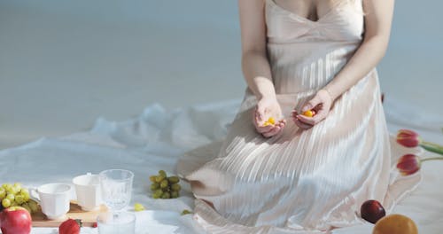 A Woman Dropping Cherry Tomatoes