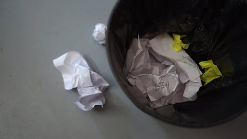 Crumpled Papers Thrown in a Trash Bin