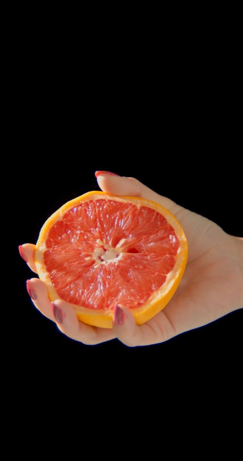 Woman Squeezing Grapefruit