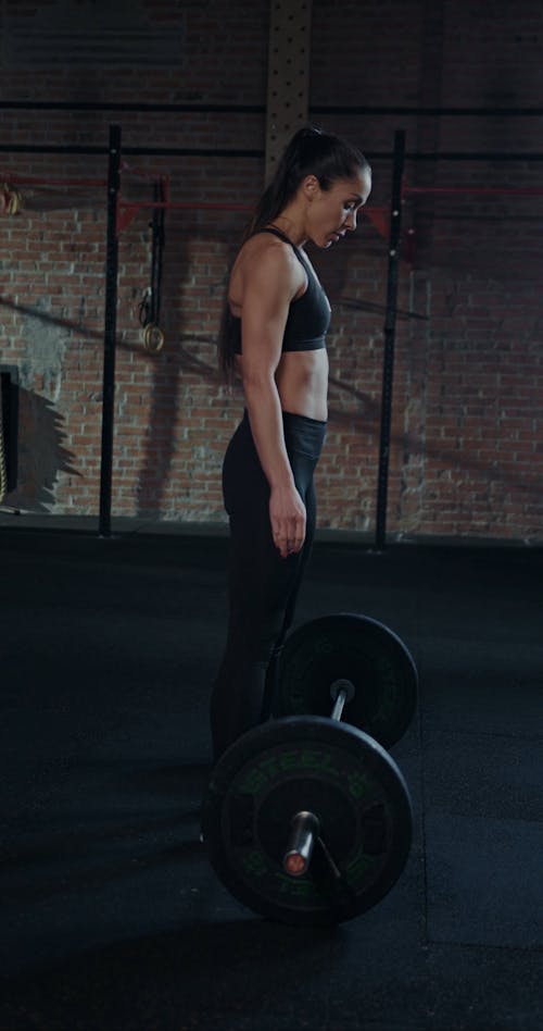 A Woman Lifting A Barbell