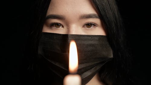 Woman Holding a Lighted Candle