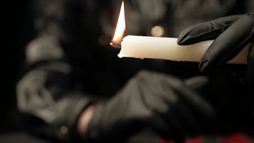 Person Holding a Lighted Candle