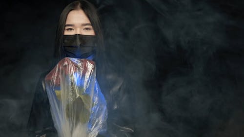 Woman Holding Flowers Covered with Plastic