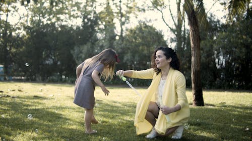 Mother and Daughter Playing Bubbles