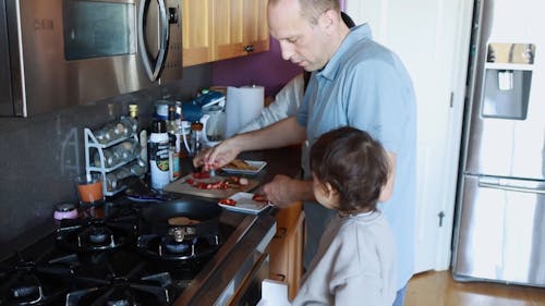 Father and Child Cooking in the Kitchen