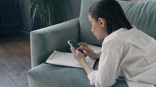 Woman Looking at Graph on Mobile Phone