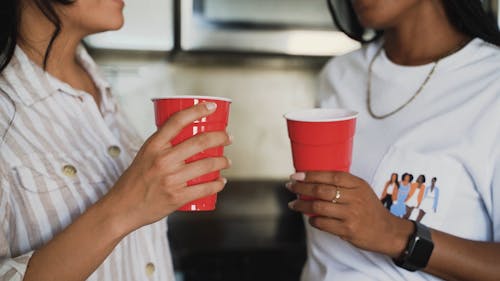 Persons Holding Plastic Cups