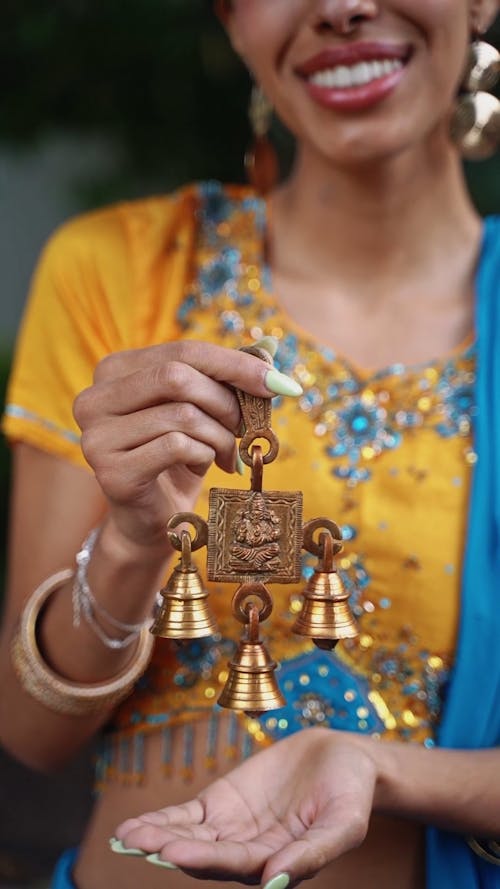 A Woman Holding a Ganesha Bells Wall Decor