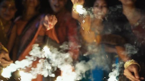 People Having Fun With Burning Sparklers