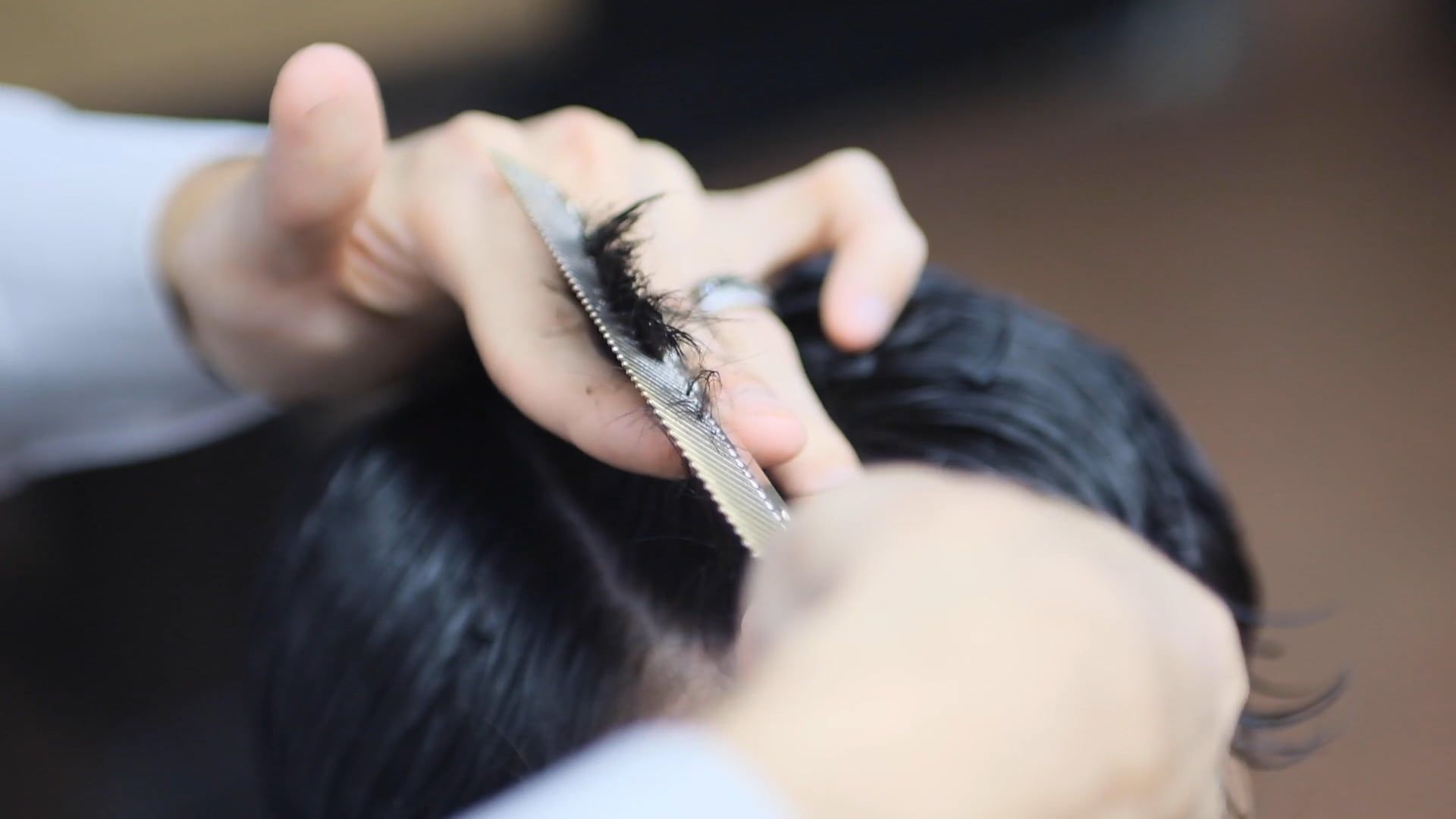 A stylist cutting hair at the chair