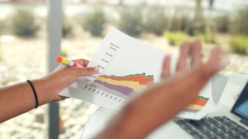 A Person Holding a Paper with Graph