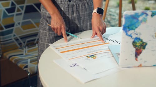 A Person Pointing to a Paperwork