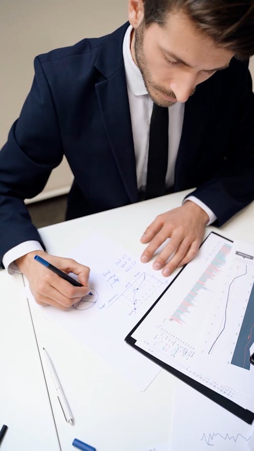 Man Writing on a Paper