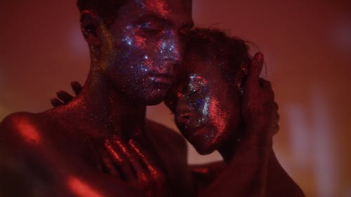 Man and Woman Covered in Glitters