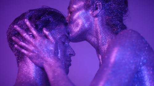 Man and Woman Covered in Glitters