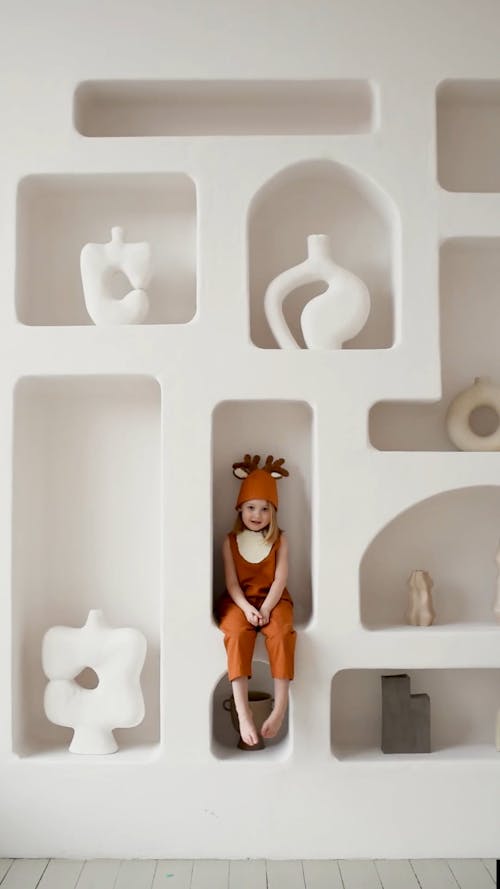 A Child Sitting on a Shelves