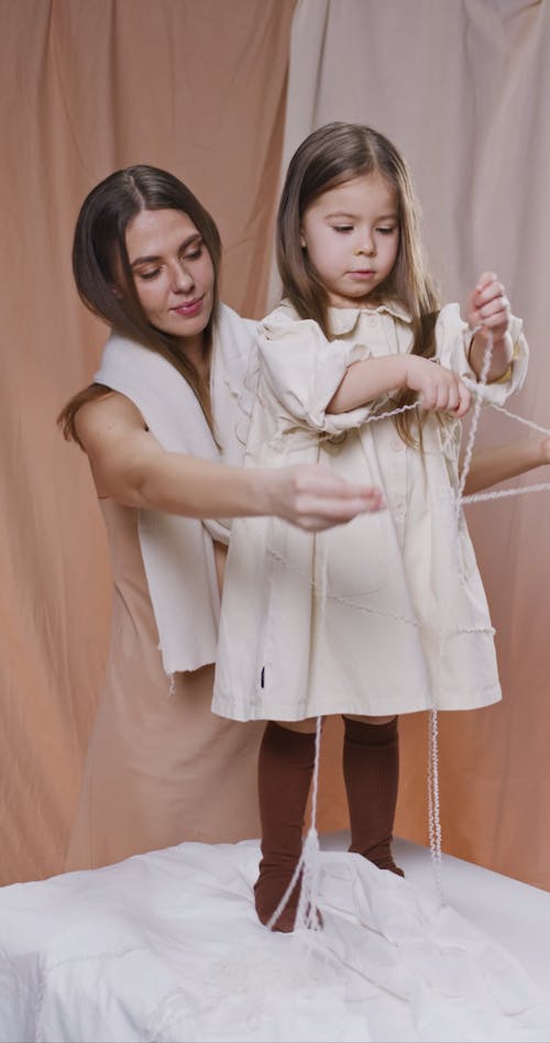 Mother and Child Playing Using a Yarn