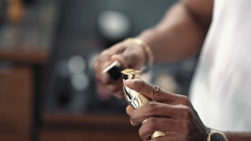 Person Cleaning an Electric Shaver with a Brush