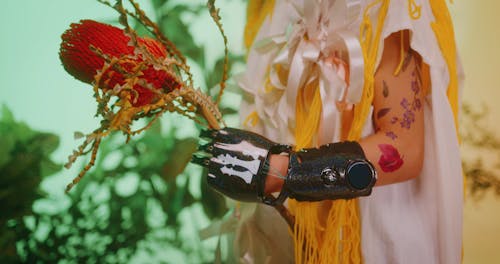 Young Girl in Diverse Clothing Holding a Flower