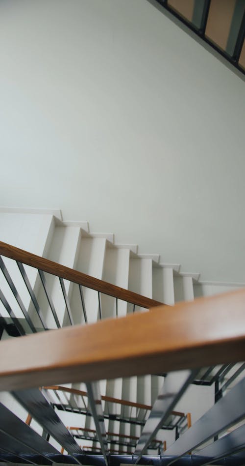 A Delivery Man Going Up the Stair while Carrying a Thermal Bag