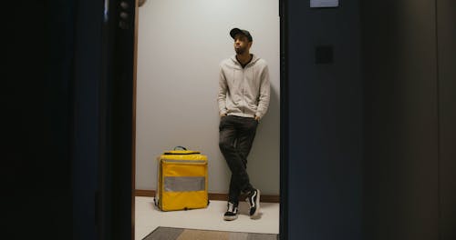 Man Waiting In Front of a Door
