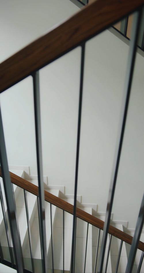 A Delivery Man Going Up the Stair while Carrying a Thermal Bag