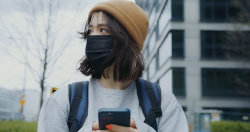 Close-Up View of a Woman Walking while Carrying a Thermal Bag