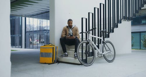 Deliveryman Sitting on the Staircase