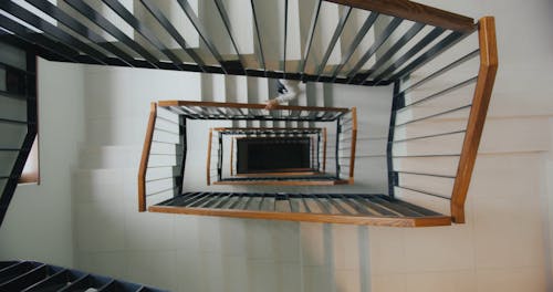 A Delivery Man Going Up the Stair while Carrying a Thermal Bag