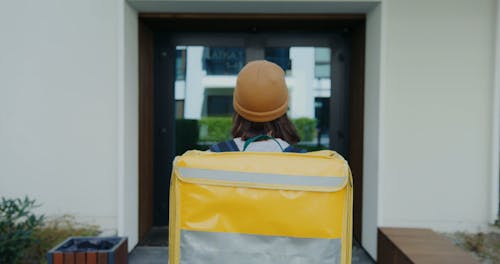 A Delivery Woman Carrying a Thermal Bag