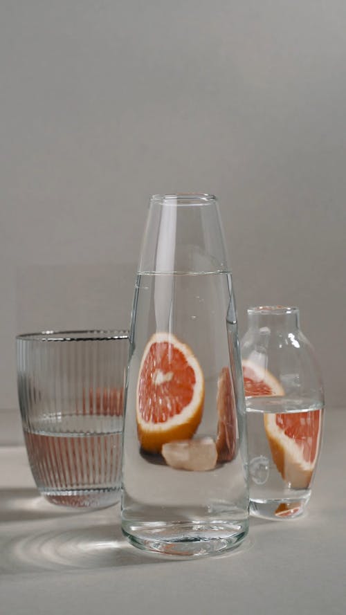 Slices of Grapefruit and a Crystal Behind Glasses of Water
