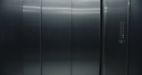 A Delivery Woman Riding an Elevator