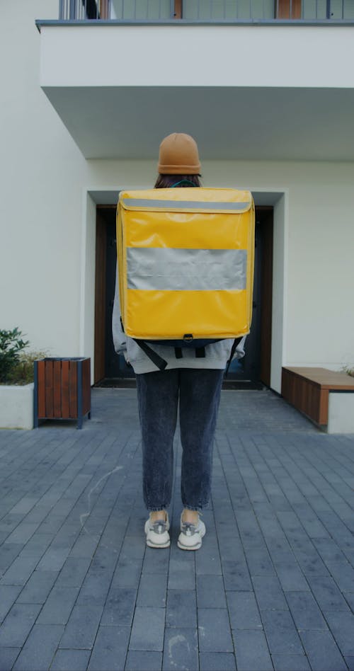 A Delivery Woman Carrying a Thermal Bag