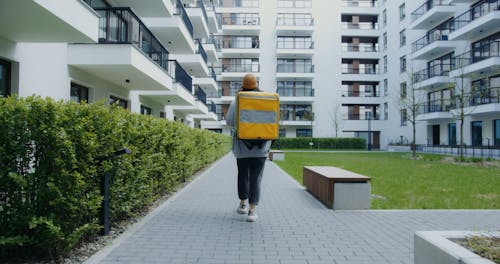 A Delivery Woman Carrying a Thermal Bag