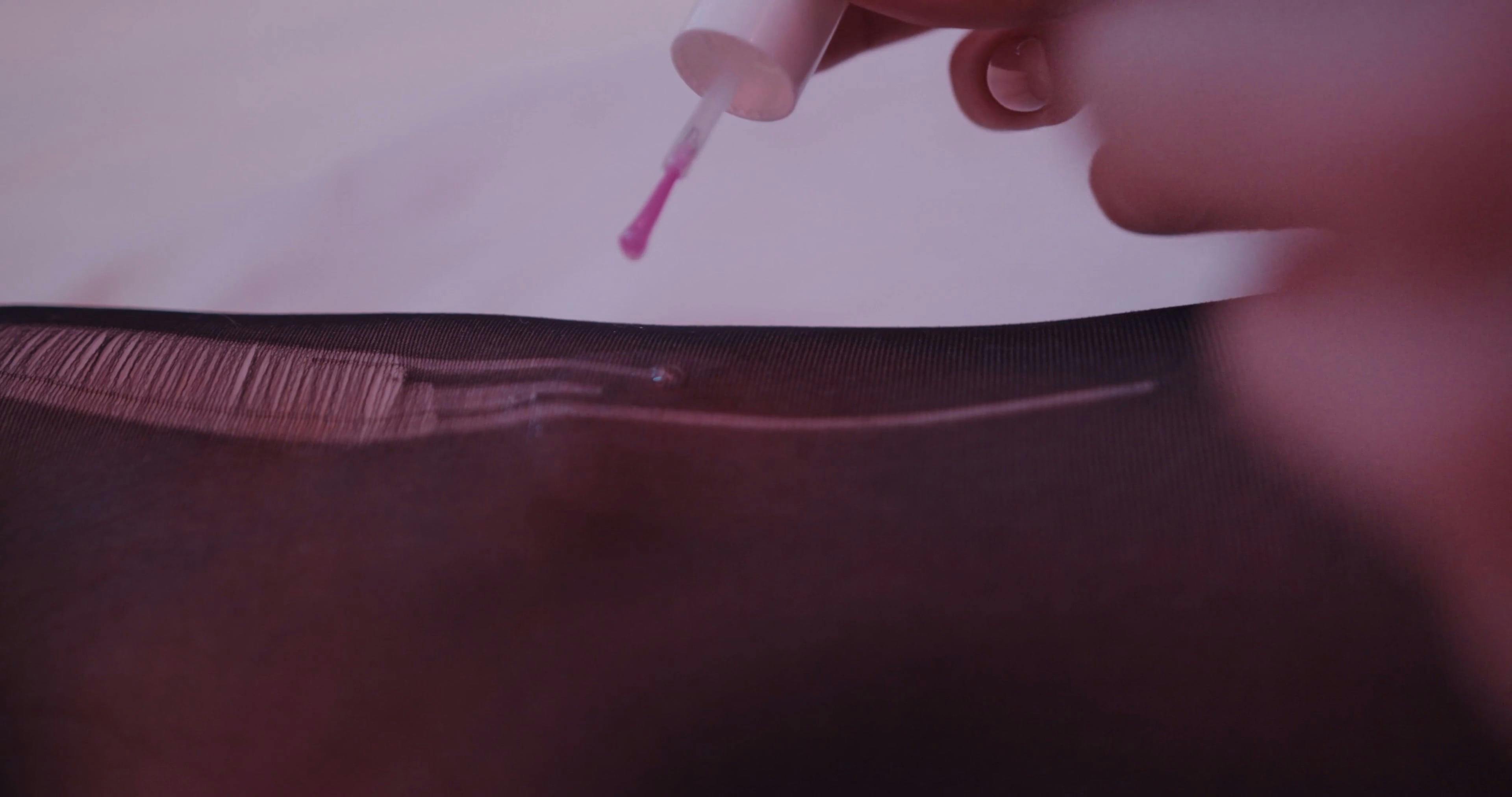 Fixing a Run in a Stockings Using a Clear Nail Polish Free Stock Video