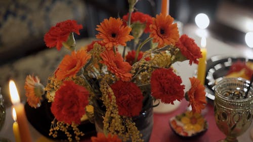 Lighted Candles and Flowers on the Table